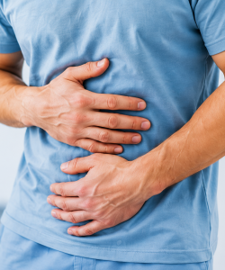 Man holding his stomach representing digestive health and gastrointestinal wellness
